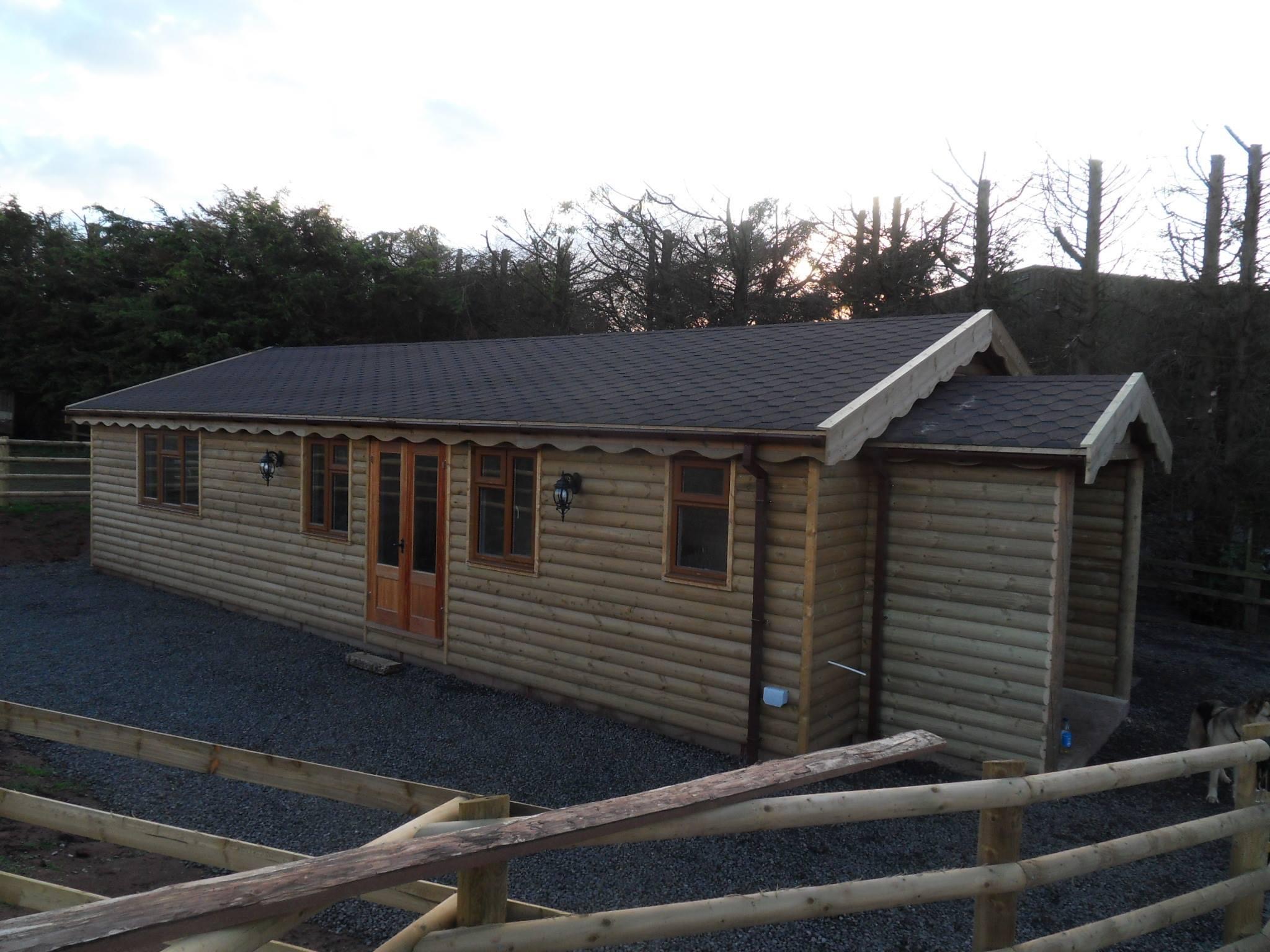  Loglap clad Chalet, which boasts two bedrooms, kitchen, bathroom and sitting room. Joinery, double glazed windows and doors, topped with a felt shingle roof - Harris Timber Products